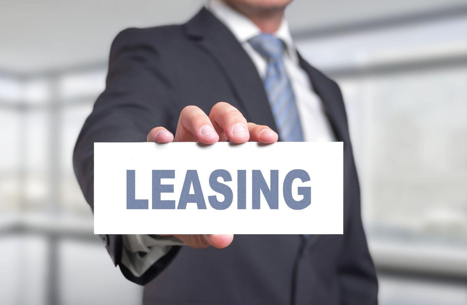 Man holding leasing sign